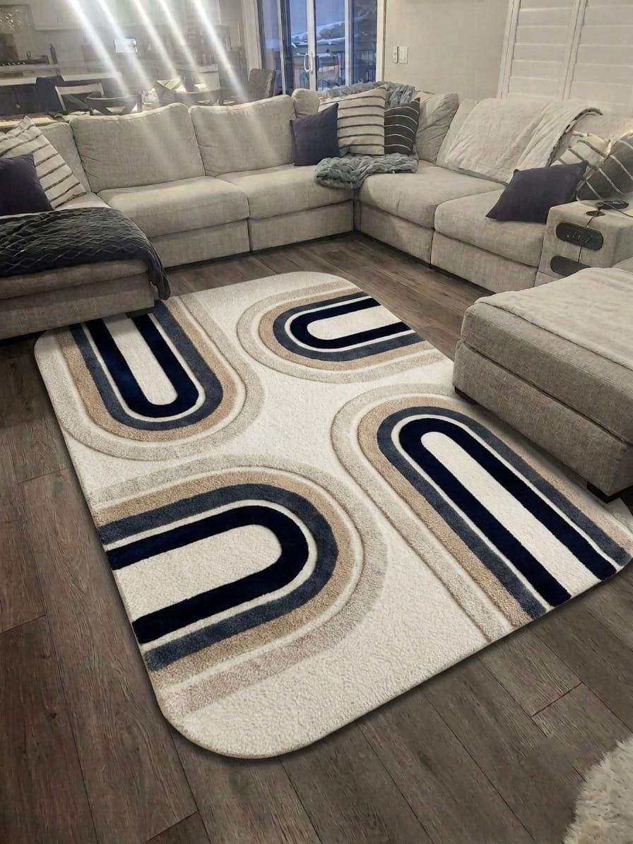  Shubham-Art-Rugs-hand-tufted-new-zealand-wool-arch-rug-navy-blue-beige-ivory-contemporary-carpet A modern area rug with a cream, beige, and navy blue geometric arch pattern, shown on a dark wood floor in a living room setting next to a light gray sectional sofa.