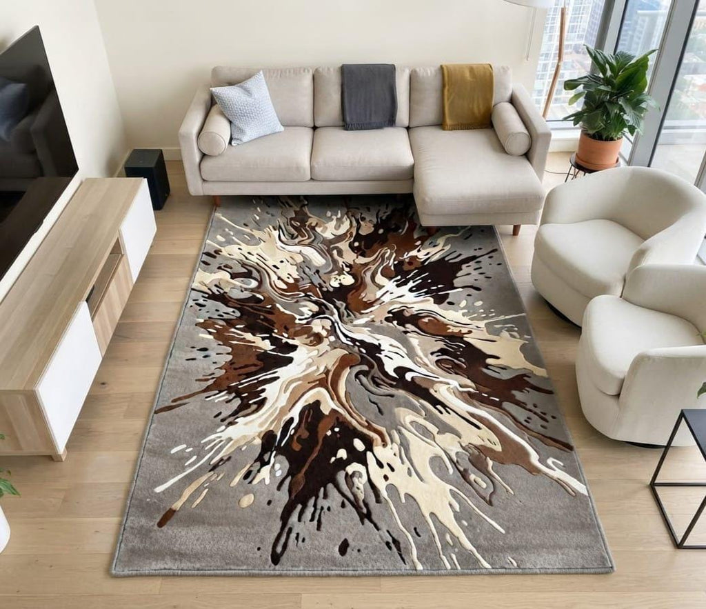 Contemporary-minimalist-living-room-interior-styling-featuring-luxury-neutral-abstract-splash-area-carpet  A rectangular area rug with a large abstract tree-bud or splash design in brown, beige, and cream on a gray background, shown in a modern living room setting.