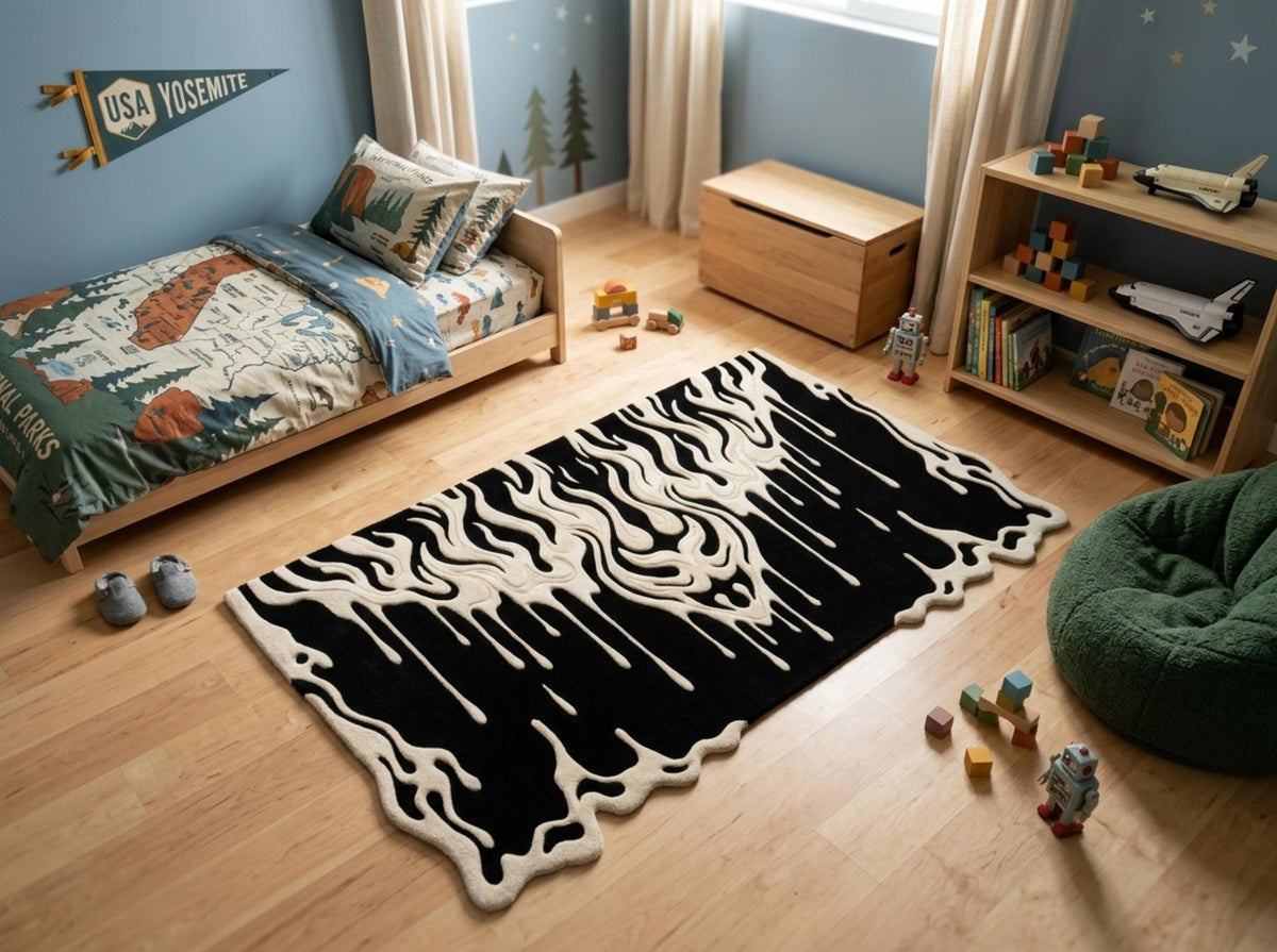 Modern-gothic-bedroom-living-room-interior-styling-featuring-luxury-monochrome-fluid-drip-irregular-area-carpet A black and cream abstract wavy patterned area rug styled in a child's bedroom with a wooden bed, toy shelves, and a green bean bag chair.